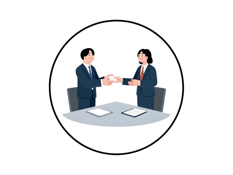 5 | Ordonna Guide Two professionals in suits shake hands over a round table with documents, symbolizing a business agreement.