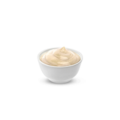 Small white bowl filled with pale beige creamy mayonnaise on a white background.