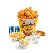 Bucket-style fried chicken with pieces, fries, a biscuit, sauces, and two blue drink cups in a meal set.